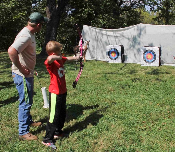 Father and son practice archery