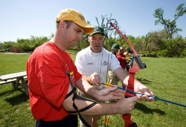 MDC volunteer helps man learn archery