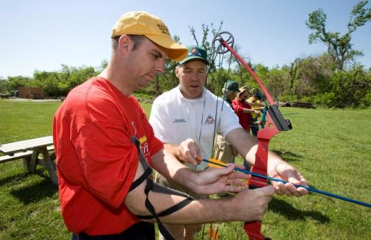 MDC volunteer helps man learn archery