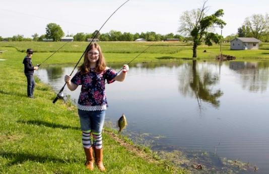 Young girl pond fishing